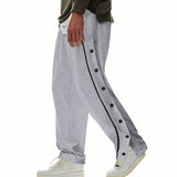 Herren nan weite Trackpants mit seitlicher Druckknopfleiste, elastischem Bund und reflektierendem Streamline-Streifen Drune in Grau